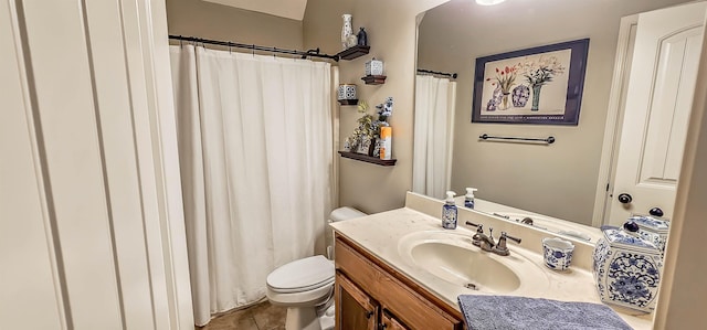 bathroom with vanity, tile patterned flooring, and toilet