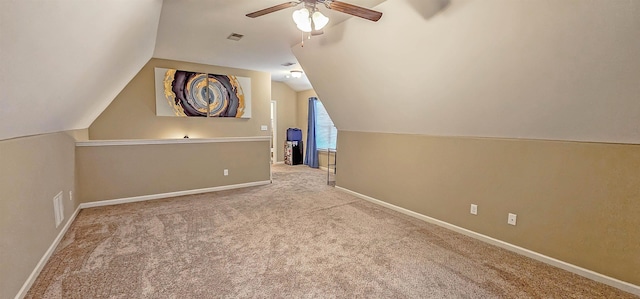 additional living space featuring ceiling fan, carpet, lofted ceiling, and visible vents