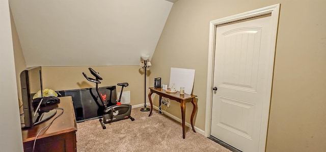 workout area featuring carpet floors, baseboards, and lofted ceiling