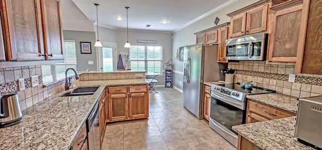 kitchen featuring a sink, appliances with stainless steel finishes, decorative backsplash, and brown cabinetry