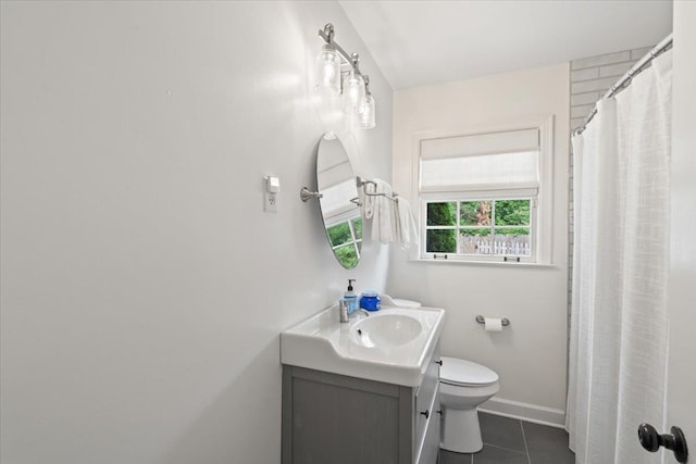 full bathroom featuring toilet, baseboards, tile patterned flooring, and vanity