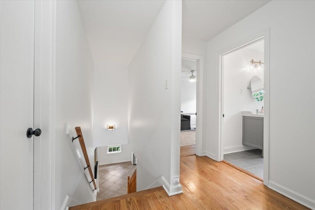 stairs with visible vents and wood finished floors