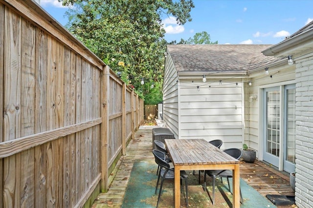 view of patio / terrace with fence, outdoor dining space, and a wooden deck