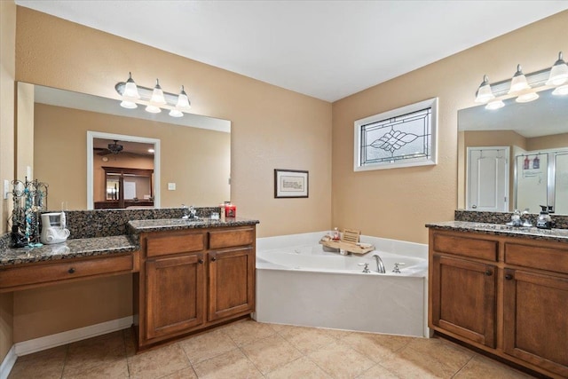 full bath featuring ceiling fan, a bath, a shower stall, two vanities, and a sink