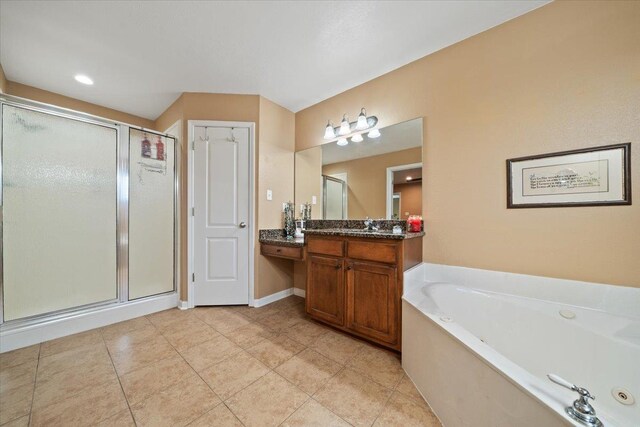 full bathroom featuring a whirlpool tub, a shower stall, tile patterned flooring, and vanity