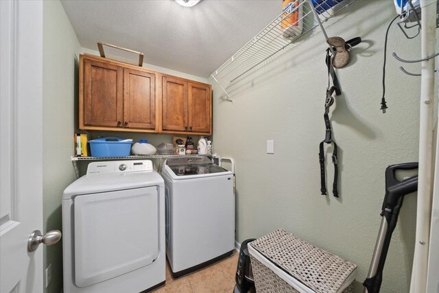 washroom featuring cabinet space and washing machine and dryer