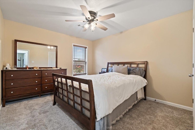 bedroom featuring a ceiling fan, baseboards, visible vents, and light carpet