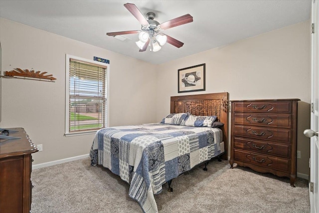 bedroom with baseboards, ceiling fan, and light carpet