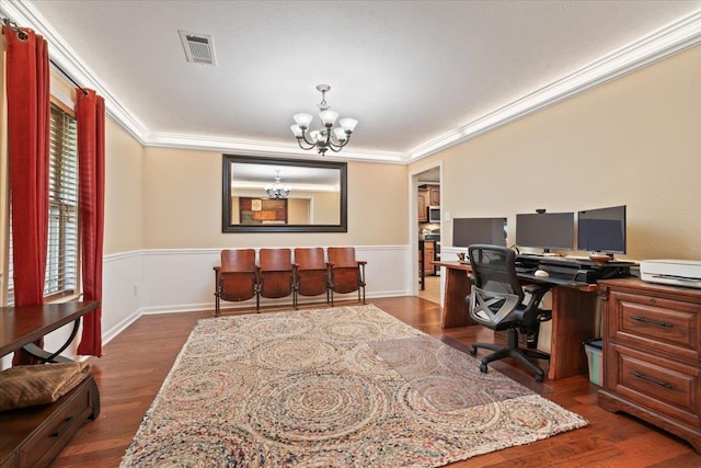 office featuring crown molding, visible vents, wainscoting, and a chandelier