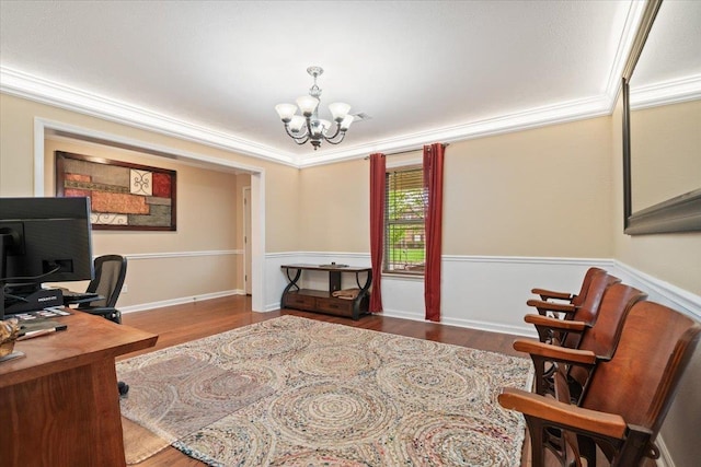 office space with ornamental molding, wood finished floors, and a chandelier
