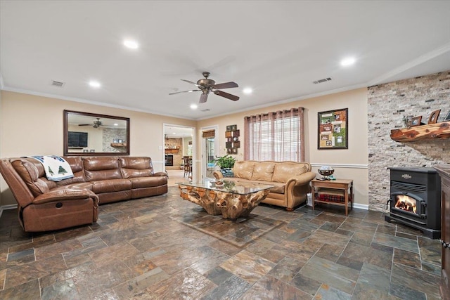 living area with baseboards, a ceiling fan, and visible vents
