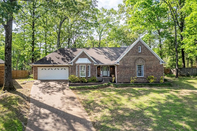 ranch-style house featuring brick siding, a garage, fence, and concrete driveway