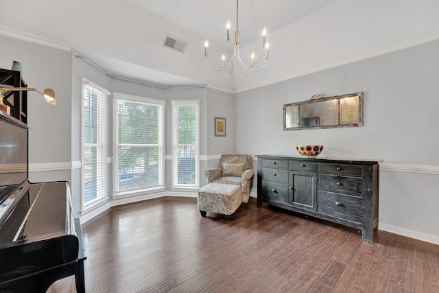 living area featuring visible vents, baseboards, wood finished floors, and a notable chandelier