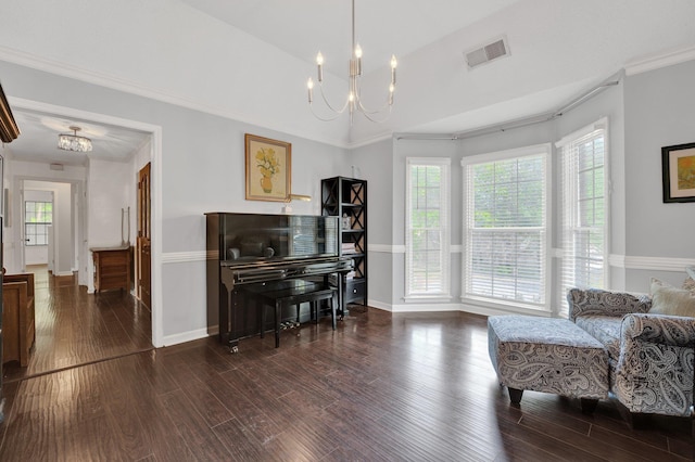living area featuring visible vents, baseboards, wood finished floors, and a notable chandelier