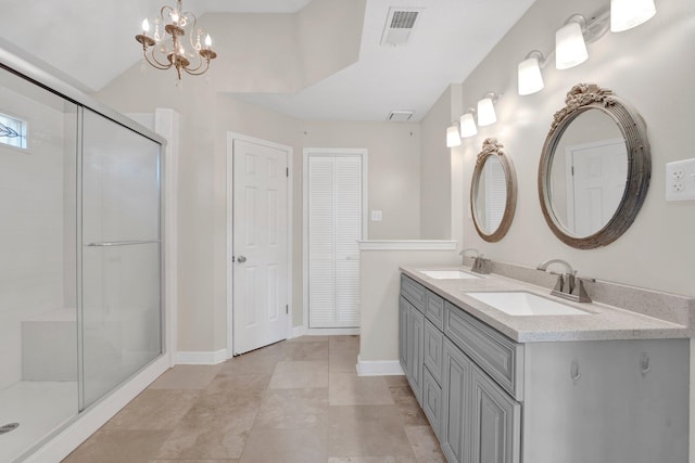 bathroom featuring visible vents, a sink, double vanity, and a shower stall