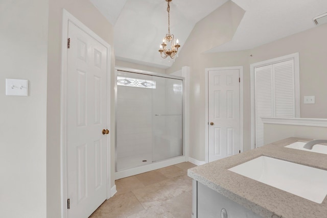 bathroom featuring vaulted ceiling, a shower stall, vanity, a closet, and an inviting chandelier