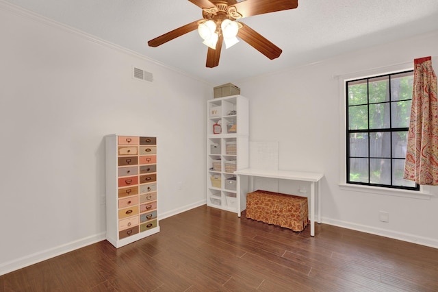 unfurnished room with ceiling fan, baseboards, wood finished floors, visible vents, and ornamental molding