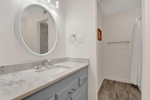 bathroom featuring baseboards, visible vents, and vanity