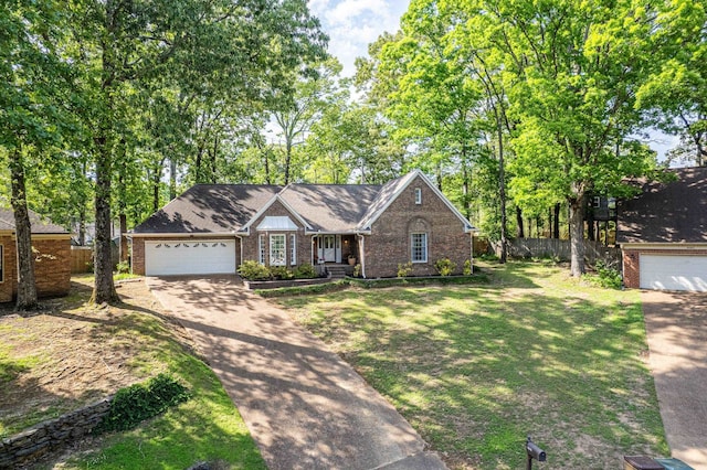 ranch-style house featuring brick siding, driveway, fence, and a garage