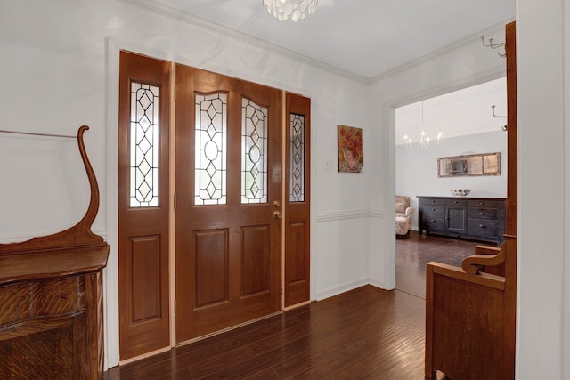 entrance foyer featuring crown molding, baseboards, an inviting chandelier, and dark wood-style floors