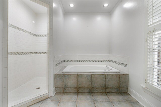 3537 Oakley Ave, Memphis, TN 38111 - bathroom featuring crown molding, a healthy amount of sunlight, tile patterned flooring, and a garden tub