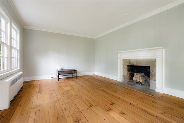 3537 Oakley Ave, Memphis, TN 38111 - unfurnished living room featuring light wood finished floors, a fireplace, radiator heating unit, baseboards, and ornamental molding