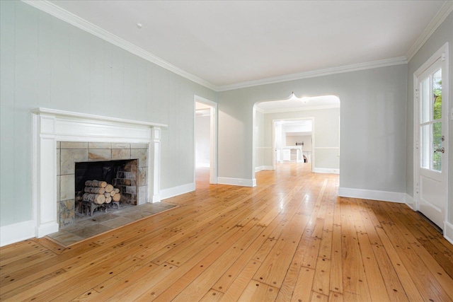 3537 Oakley Ave, Memphis, TN 38111 - unfurnished living room featuring a tiled fireplace, baseboards, crown molding, and hardwood / wood-style floors