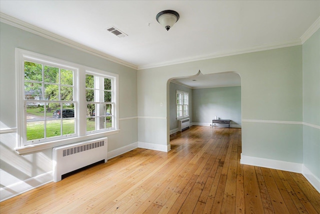 3537 Oakley Ave, Memphis, TN 38111 - unfurnished room with baseboards, arched walkways, radiator, and visible vents