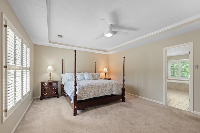 bedroom with ceiling fan, visible vents, carpet floors, baseboards, and ensuite bath