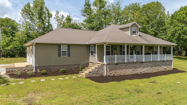 view of front facade with a porch, a shingled roof, and a front yard