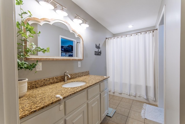 full bath with shower / tub combo with curtain, tile patterned flooring, and vanity