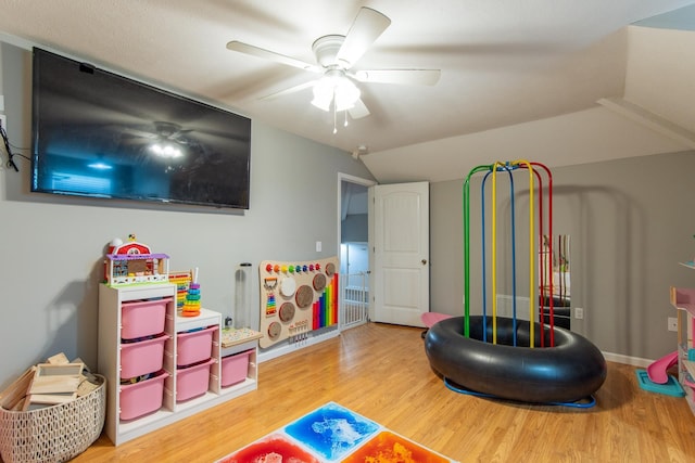 recreation room with ceiling fan, wood finished floors, and lofted ceiling