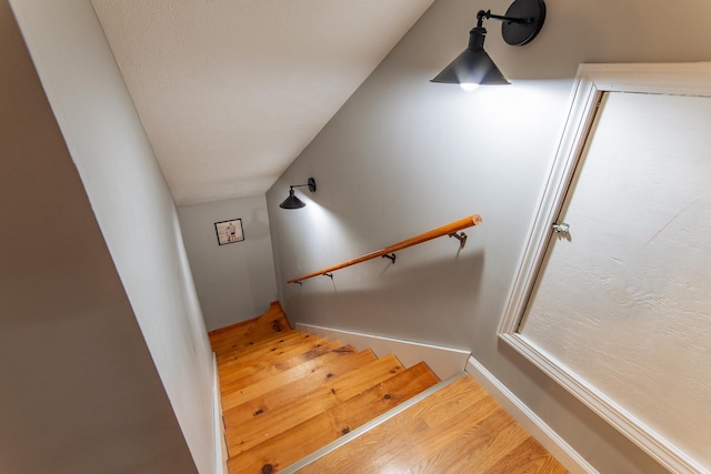 stairs featuring wood finished floors