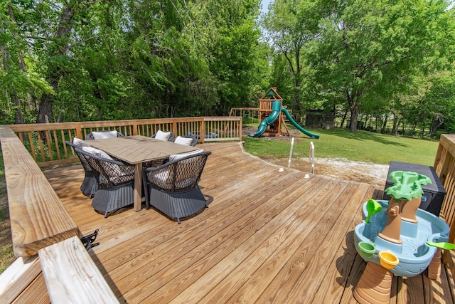deck with a playground, a yard, and outdoor dining space