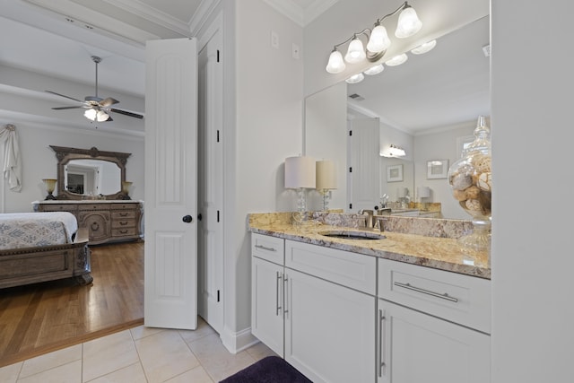 full bathroom featuring a ceiling fan, crown molding, tile patterned flooring, vanity, and baseboards