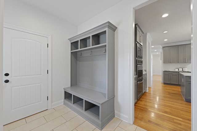 mudroom featuring baseboards, light wood-type flooring, and recessed lighting