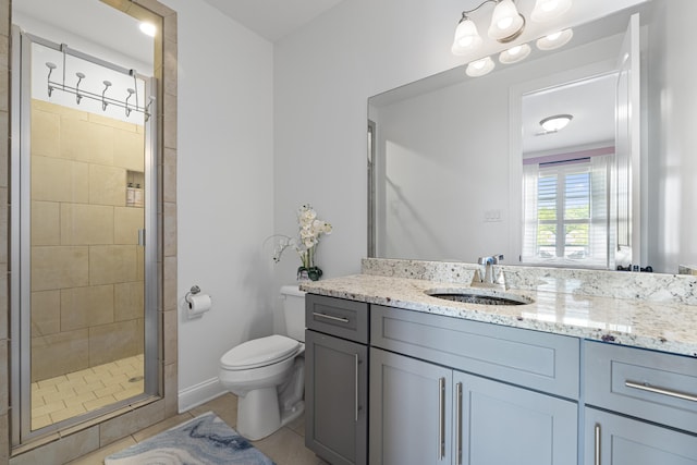 full bathroom featuring vanity, tile patterned flooring, a stall shower, and toilet