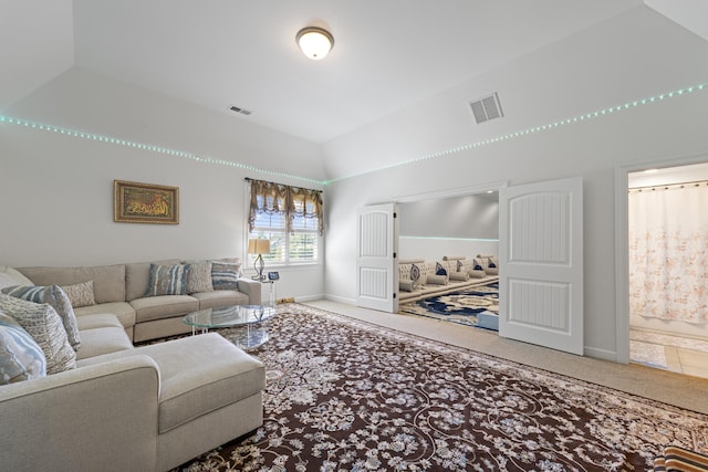 living area featuring baseboards, visible vents, carpet, and high vaulted ceiling