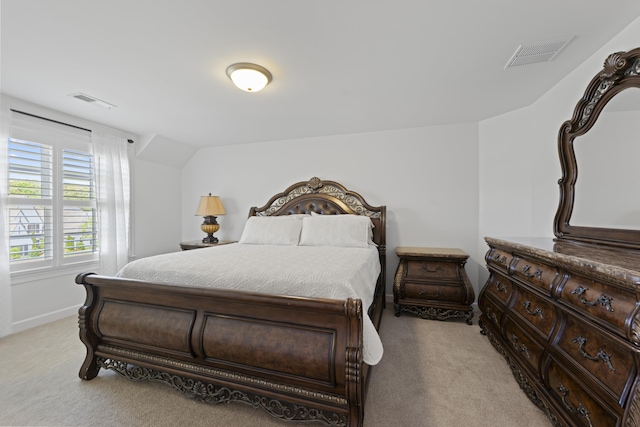 bedroom with light colored carpet, baseboards, and visible vents