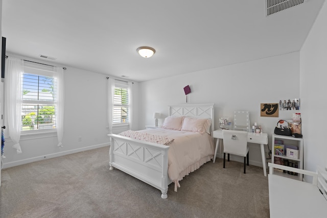 carpeted bedroom featuring baseboards and visible vents