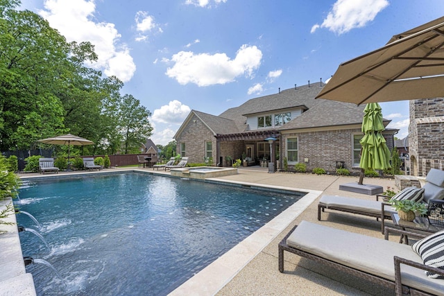 view of pool with a pergola, a pool with connected hot tub, fence, and a patio area