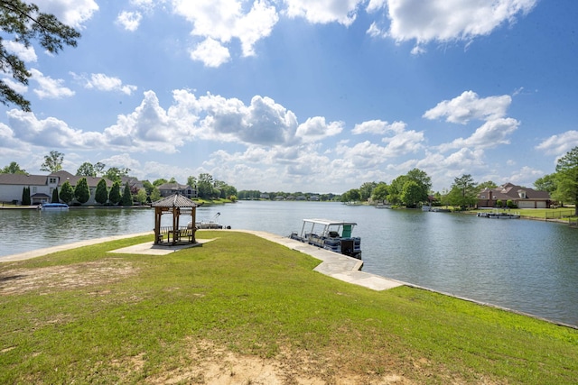view of dock featuring a gazebo, a water view, and a lawn