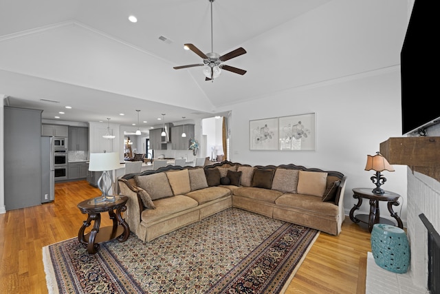 living area with light wood-style floors, a ceiling fan, lofted ceiling, and recessed lighting