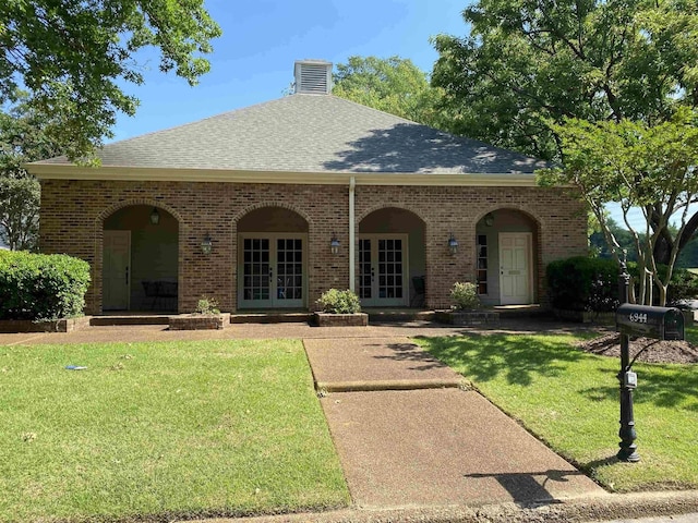 6905 Petworth Rd Unit 6905, Memphis, TN 38119 - view of front facade with french doors, a front lawn, brick siding, and roof with shingles
