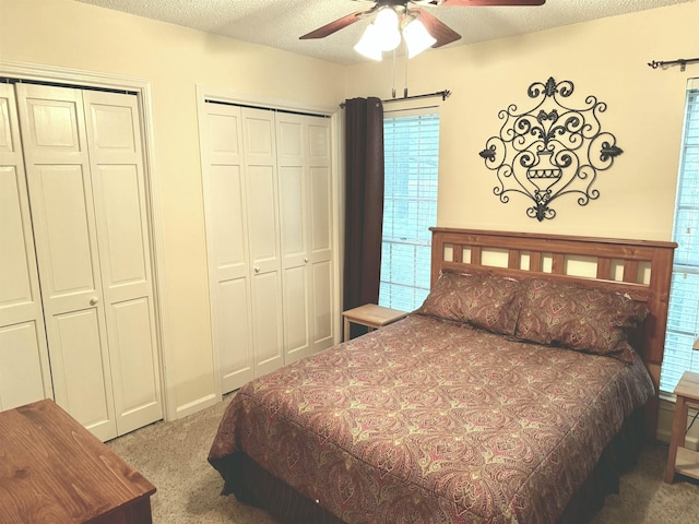 6905 Petworth Rd Unit 6905, Memphis, TN 38119 - carpeted bedroom with multiple closets, a textured ceiling, and ceiling fan