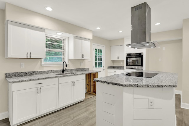1296 Monasco Rd, Millington, TN 38053 - kitchen with island range hood, a sink, light stone counters, white cabinets, and black appliances