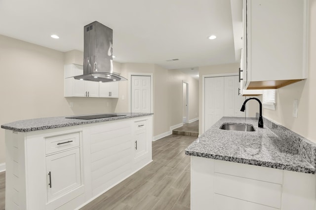 1296 Monasco Rd, Millington, TN 38053 - kitchen with light stone counters, a sink, black electric cooktop, baseboards, and island exhaust hood