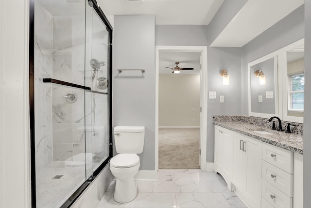 1296 Monasco Rd, Millington, TN 38053 - full bathroom with toilet, baseboards, ceiling fan, and a marble finish shower