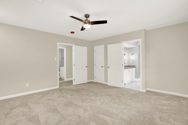 1296 Monasco Rd, Millington, TN 38053 - unfurnished bedroom with baseboards, ensuite bathroom, and light carpet