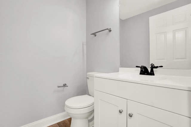 1296 Monasco Rd, Millington, TN 38053 - bathroom with baseboards, vanity, toilet, and wood finished floors